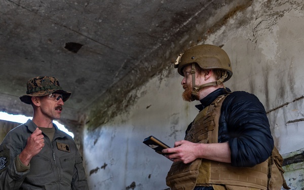 U.S. Marine Corps explosive ordnance disposal technicians engage with international media in Latvia