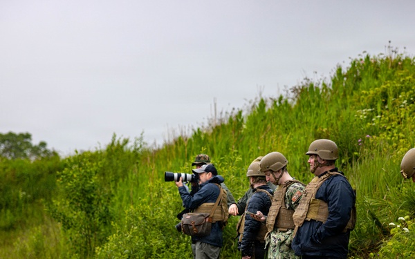 U.S. Marine Corps explosive ordnance disposal technicians engage with international media in Latvia