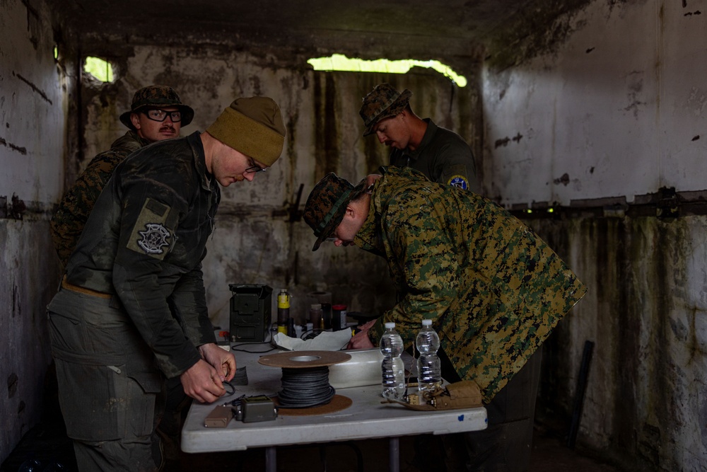 U.S. Marine Corps explosive ordnance disposal technicians engage with international media in Latvia