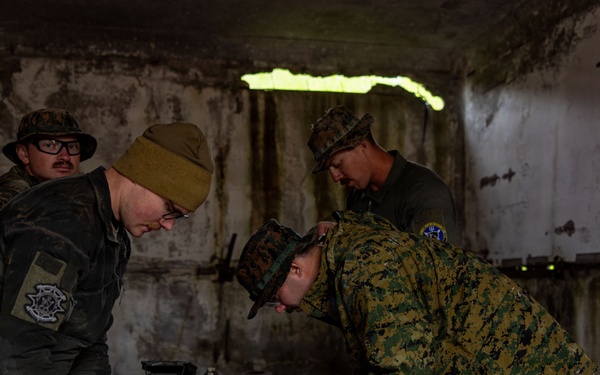 U.S. Marine Corps explosive ordnance disposal technicians engage with international media in Latvia