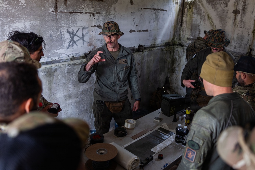 U.S. Marine Corps explosive ordnance disposal technicians engage with international media in Latvia