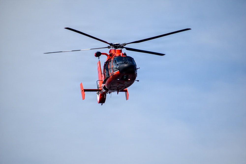 USCG MH-65 Dolphin flies over USCGC Eagle