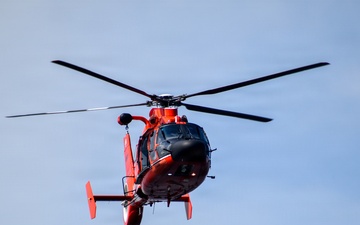 USCG MH-65 Dolphin flies over USCGC Eagle