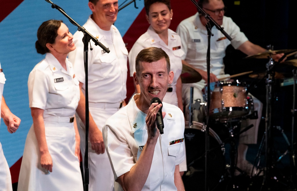 U.S. Navy personnel perform during a live musical concert