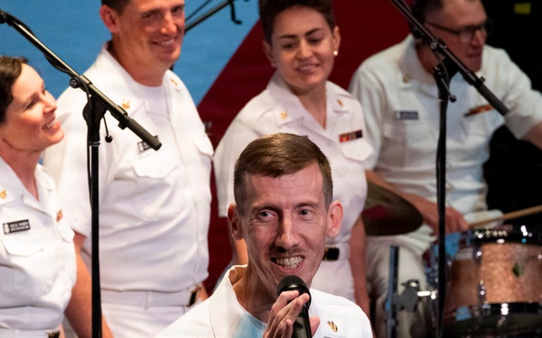 U.S. Navy personnel perform during a live musical concert