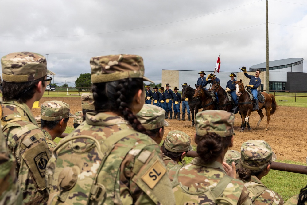 Reserve Officers' Training Corps (JROTC) watch 1st Cavalry Division Horse Cavalry Detachment demonstration