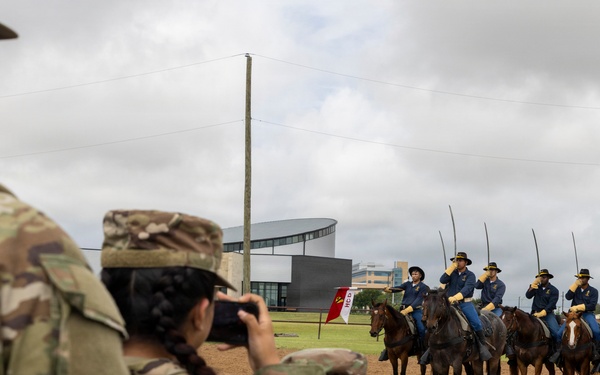 Reserve Officers' Training Corps (JROTC) watch 1st Cavalry Division Horse Cavalry Detachment demonstration