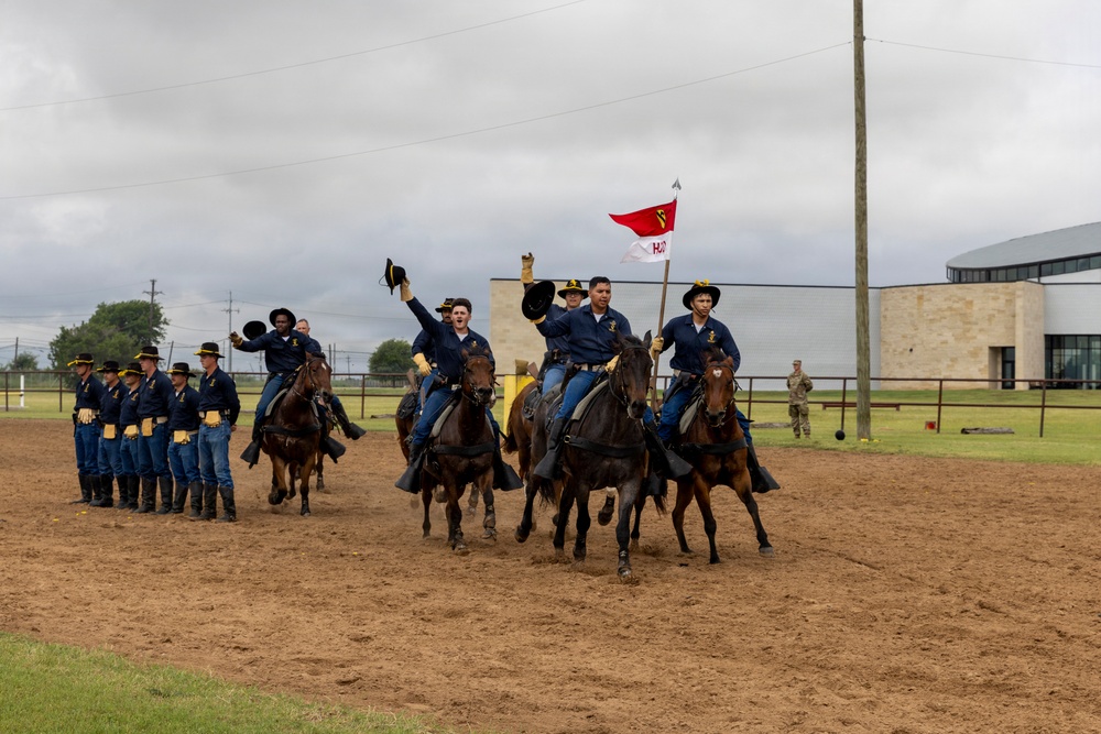 Reserve Officers' Training Corps (JROTC) watch 1st Cavalry Division Horse Cavalry Detachment demonstration