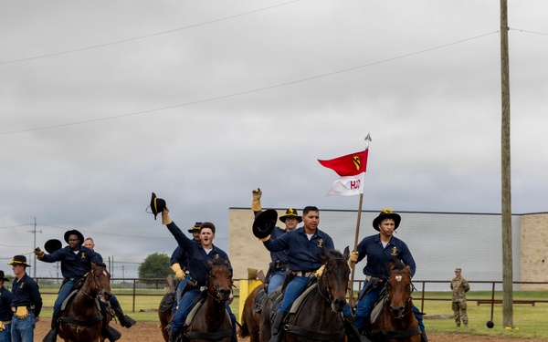 Reserve Officers' Training Corps (JROTC) watch 1st Cavalry Division Horse Cavalry Detachment demonstration
