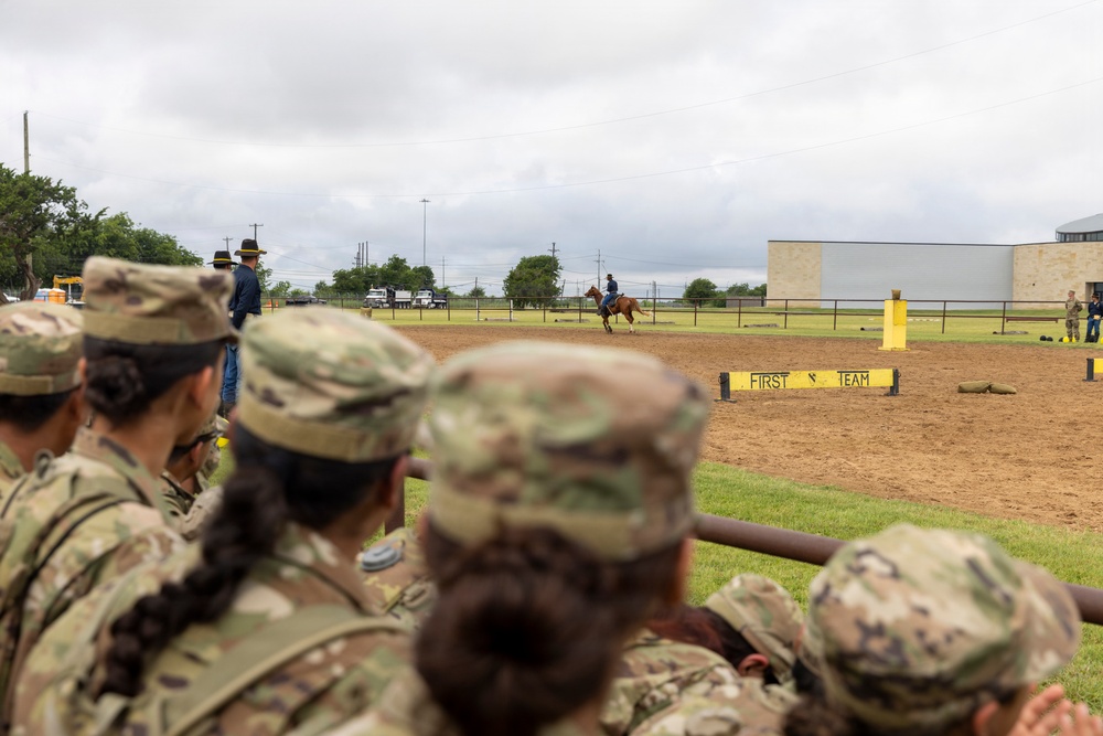 Reserve Officers' Training Corps (JROTC) watch 1st Cavalry Division Horse Cavalry Detachment demonstration