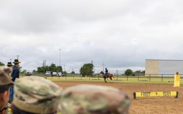 Reserve Officers' Training Corps (JROTC) watch 1st Cavalry Division Horse Cavalry Detachment demonstration