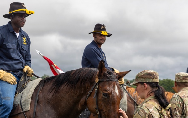 Reserve Officers' Training Corps (JROTC) watch 1st Cavalry Division Horse Cavalry Detachment demonstration