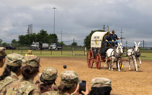 Reserve Officers' Training Corps (JROTC) watch 1st Cavalry Division Horse Cavalry Detachment demonstration