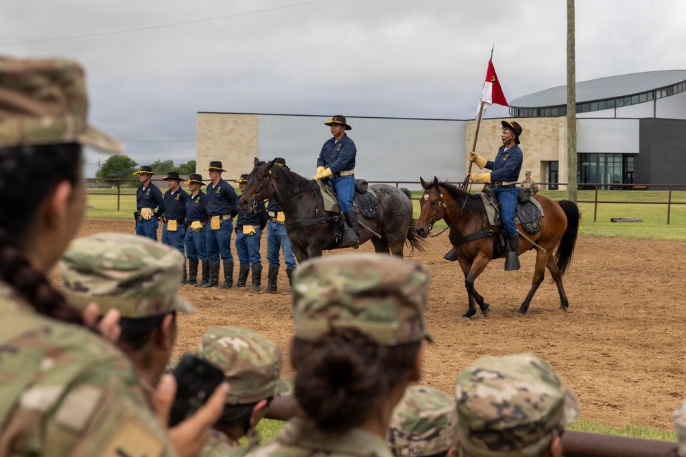Reserve Officers' Training Corps (JROTC) watch 1st Cavalry Division Horse Cavalry Detachment demonstration