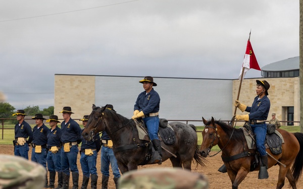 Reserve Officers' Training Corps (JROTC) watch 1st Cavalry Division Horse Cavalry Detachment demonstration