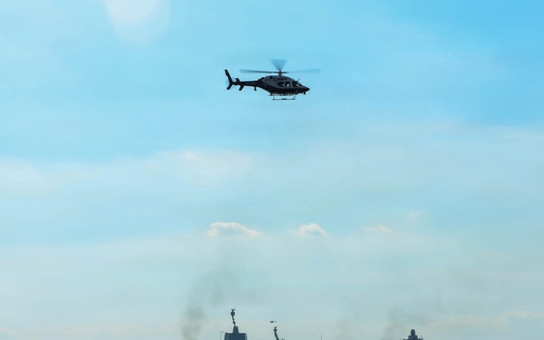 USS Arlington (LPD 24) sails past Statue of Liberty