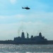 USS Arlington (LPD 24) sails past Statue of Liberty
