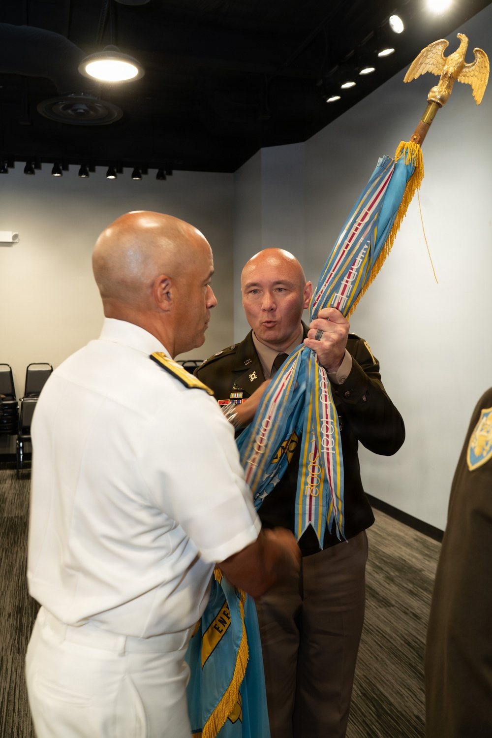Military Officers Conduct Colors Transfer During Change of Command Ceremony