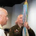 Commander Holds Unit Colors with Streamer During Military Ceremony