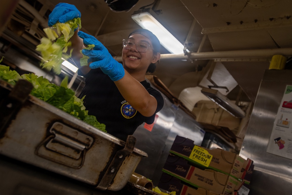 USS Nimitz Sailor Chops Lettuce