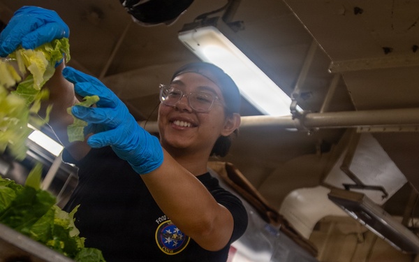 USS Nimitz Sailor Chops Lettuce