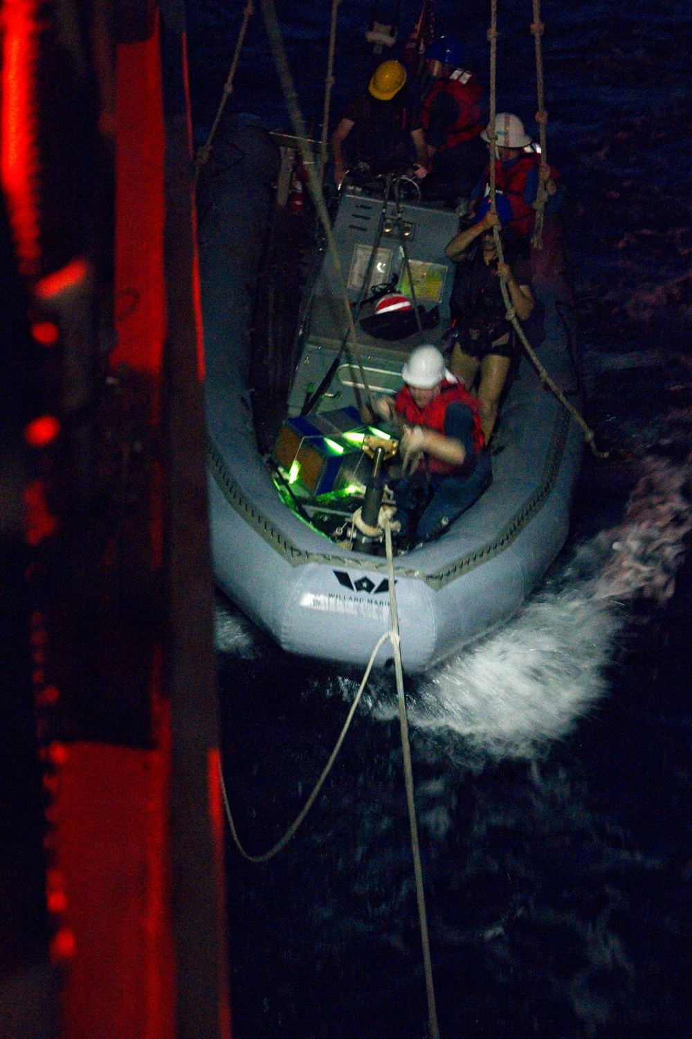 Sailors Conduct Nighttime Small Boat Operations from Naval Vessel