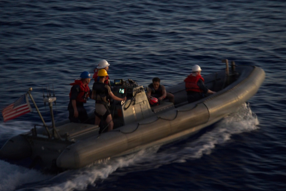 U.S. Navy Sailors operate a rigid-hull inflatable boat during maritime operations at sea