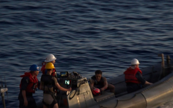 U.S. Navy Sailors operate a rigid-hull inflatable boat during maritime operations at sea