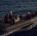 U.S. Navy Sailors operate a rigid-hull inflatable boat during maritime operations at sea