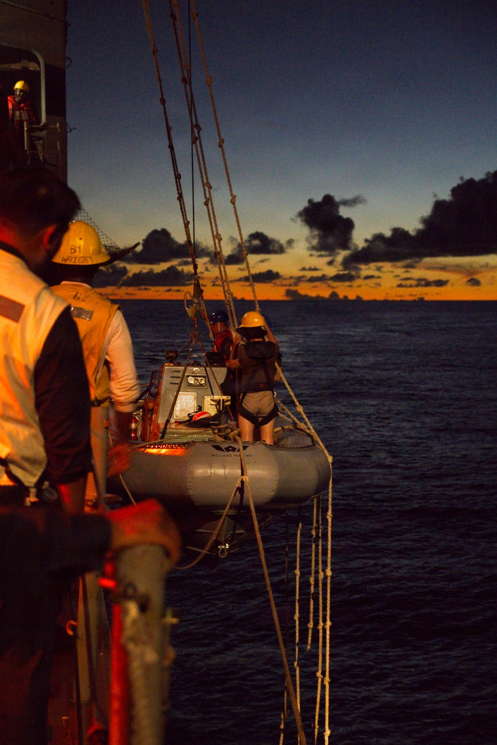 Sailors Raising Rigid-Hull Inflatable Boat During Maritime Operations