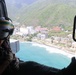 A U.S. Naval Aircrewman (Helicopter) scans the horizon from an MH-60R Seahawk, assigned to Helicopter Maritime Strike Squadron (HSM) 48 during flight operations off the coast of Venezuela, June 29, 2026.