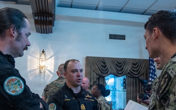 Multinational service members review a SINKEX brief during Exercise Rim of the Pacific 26