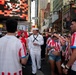 U.S. Navy sailor walks through Times Square during Sail 250
