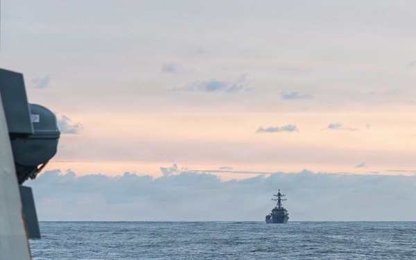 USS Mustin conducts a replenishment-at-sea with USNS Wally Schirra