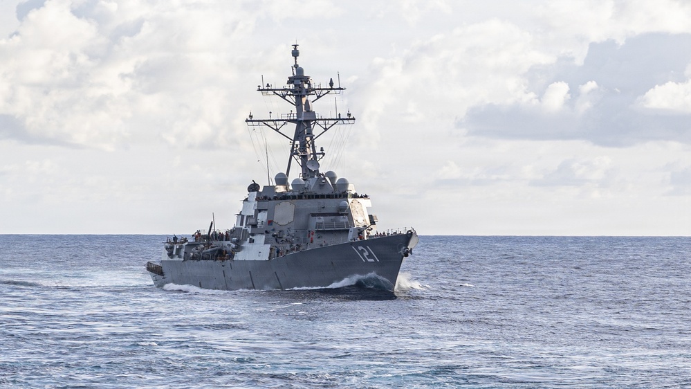 USS Mustin conducts a replenishment-at-sea with USNS Wally Schirra