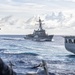 USS Mustin conducts a replenishment-at-sea with USNS Wally Schirra