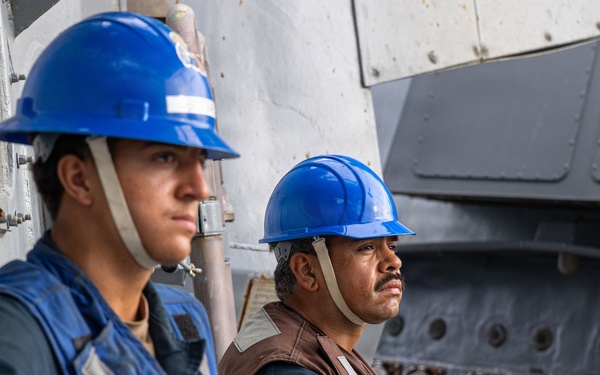 USS Mustin conducts a replenishment-at-sea with USNS Wally Schirra