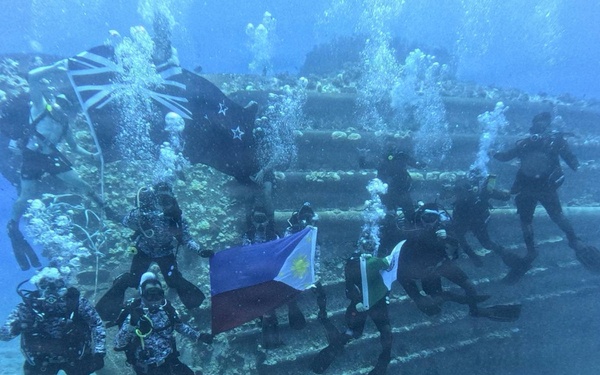 PCG, Royal New Zealand Navy Divers Display National Flags During RIMPAC 2026