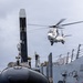 USS Mustin conducts a replenishment-at-sea with USNS Wally Schirra