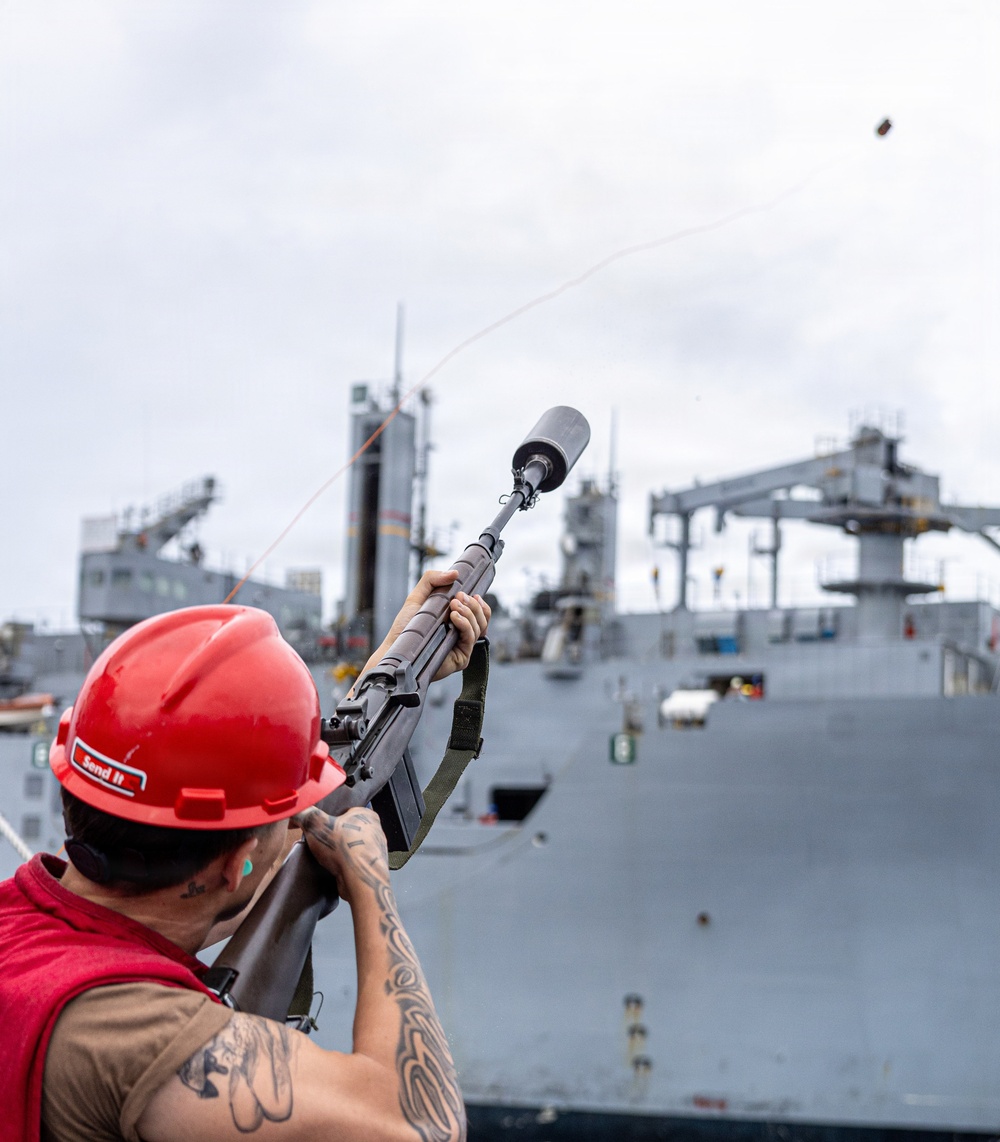 USS Mustin conducts a replenishment-at-sea with USNS Wally Schirra