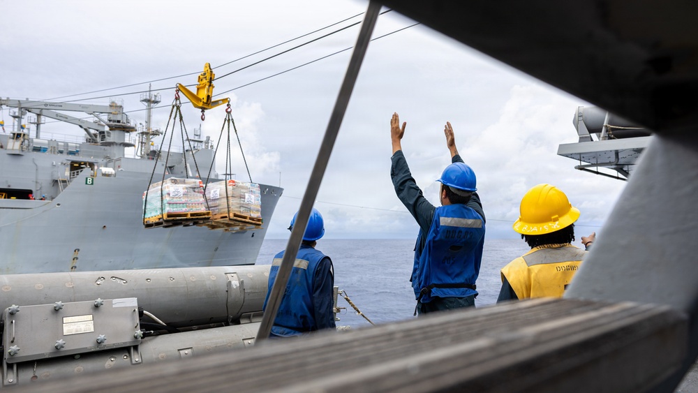 USS Mustin conducts a replenishment-at-sea with USNS Wally Schirra