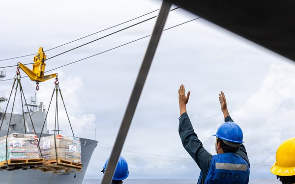 USS Mustin conducts a replenishment-at-sea with USNS Wally Schirra