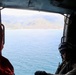 A U.S. Naval Aircrewman (Helicopter) scans the horizon from an MH-60R Seahawk, assigned to Helicopter Maritime Strike Squadron (HSM) 48.