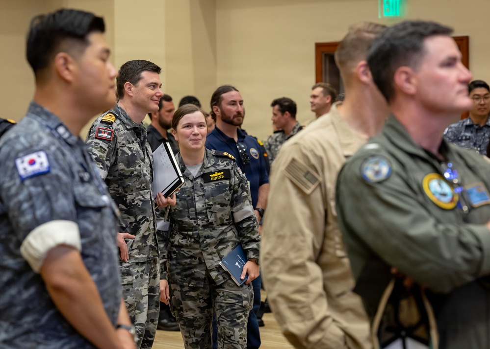 Multinational ship commands attend the PHOTOEX brief for RIMPAC 2026