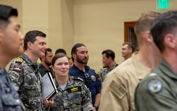 Multinational ship commands attend the PHOTOEX brief for RIMPAC 2026