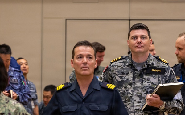 Multinational ship commands attend the PHOTOEX brief for RIMPAC 2026
