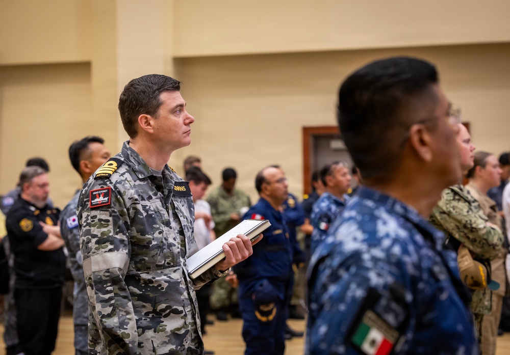 Multinational ship commands attend the PHOTOEX brief for RIMPAC 2026