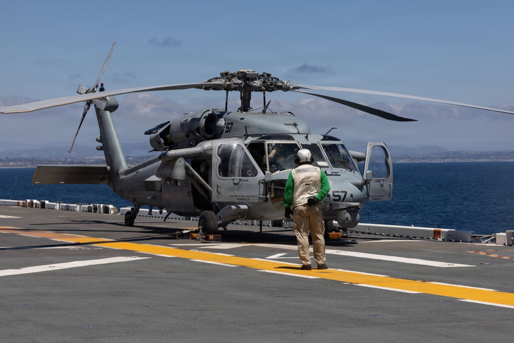 MV-22B Ospreys and MH-60 Seahawk execute embarking procedures on USS Makin Island