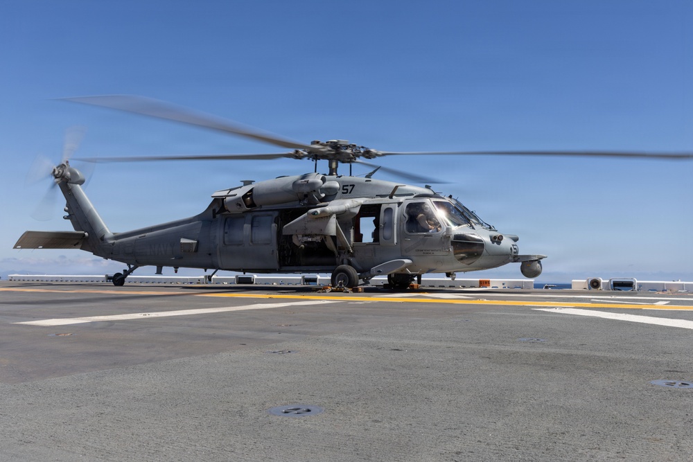 MV-22B Ospreys and MH-60 Seahawk execute embarking procedures on USS Makin Island