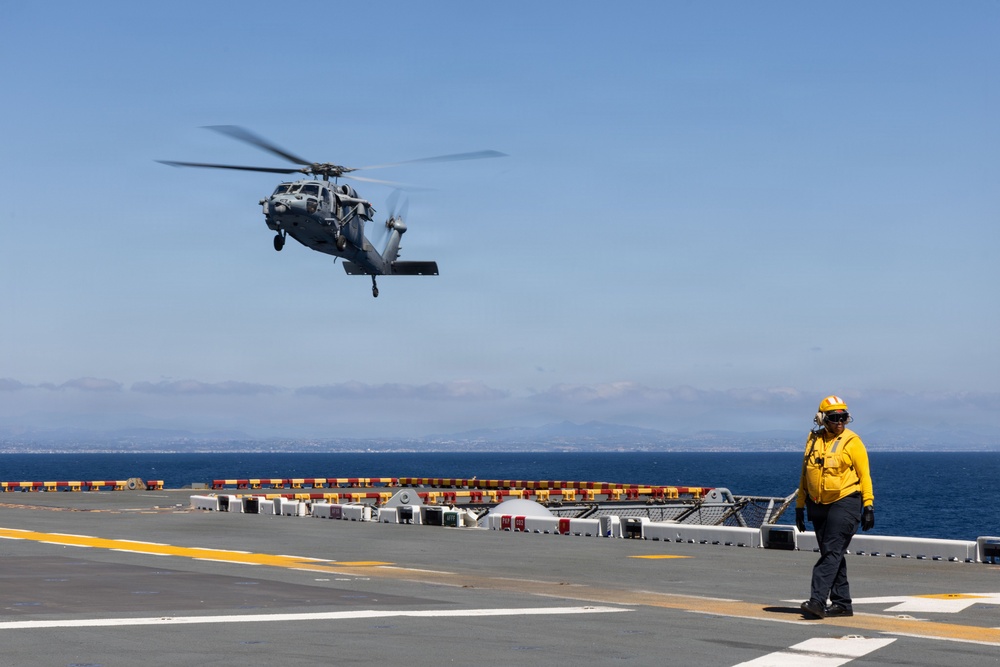 MV-22B Ospreys and MH-60 Seahawk execute embarking procedures on USS Makin Island